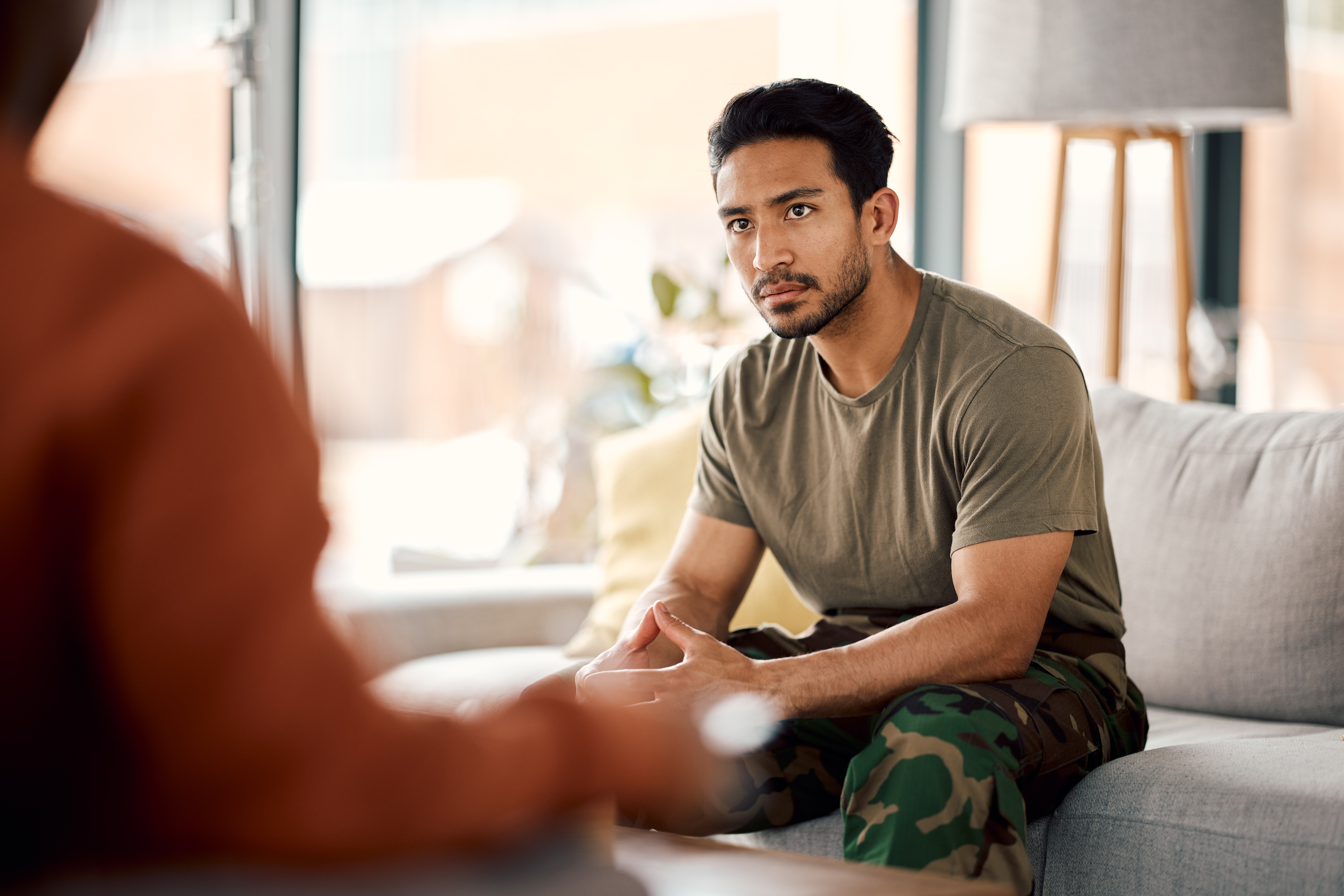 Young middle-eastern a young army, veteran or soldier man with a therapist for mental health, consultation or help